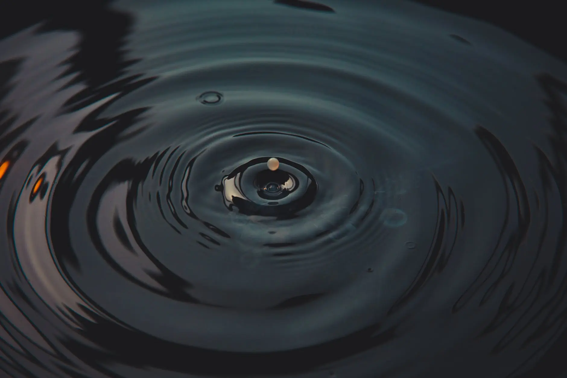 water drop in water in close up photography